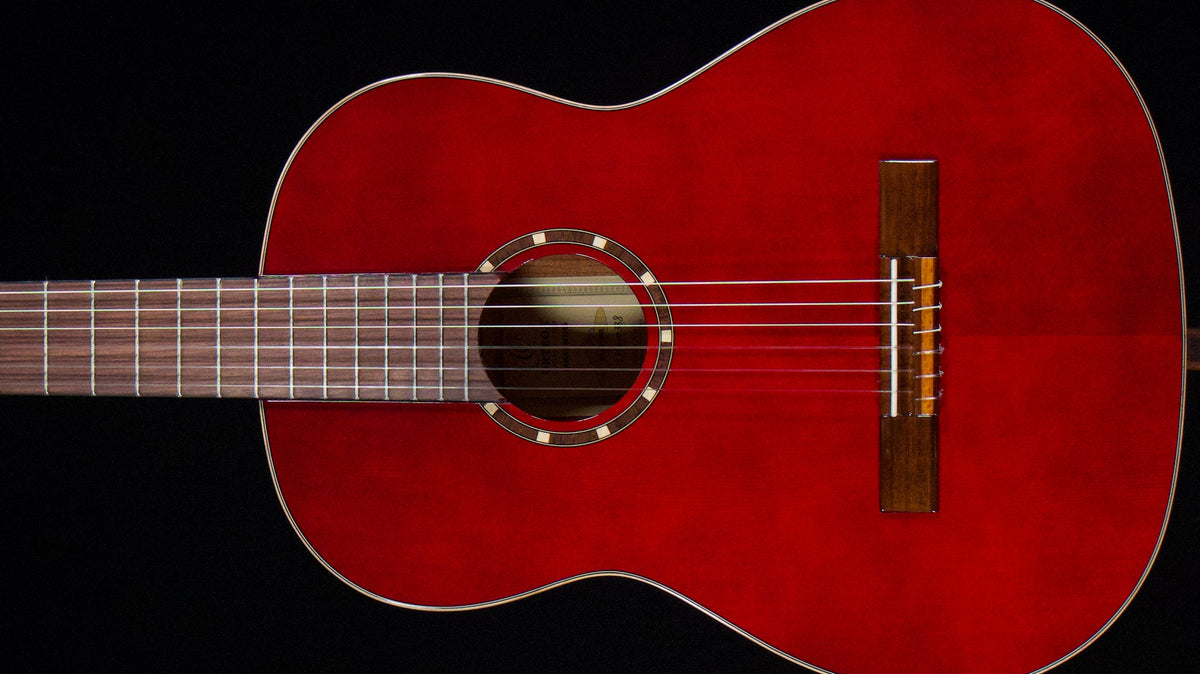 Left-handed Ortega classical acoustic guitar in a warm red finish