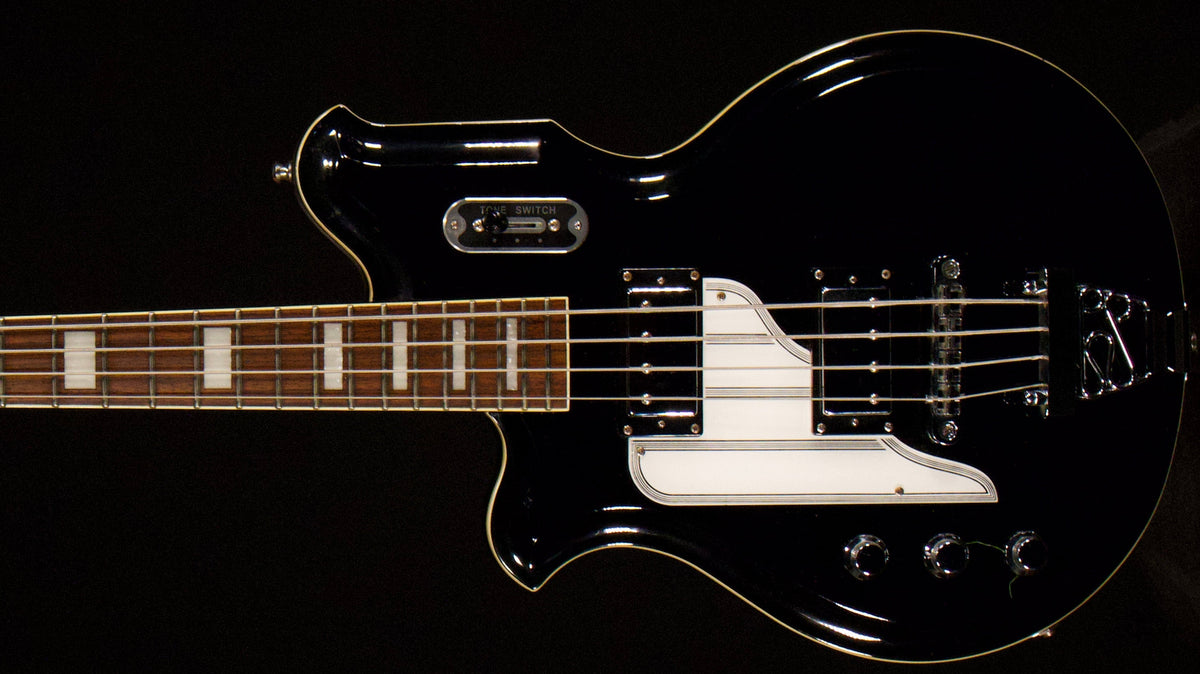 Left-handed Airline MAP Bass shown close up against a dark background