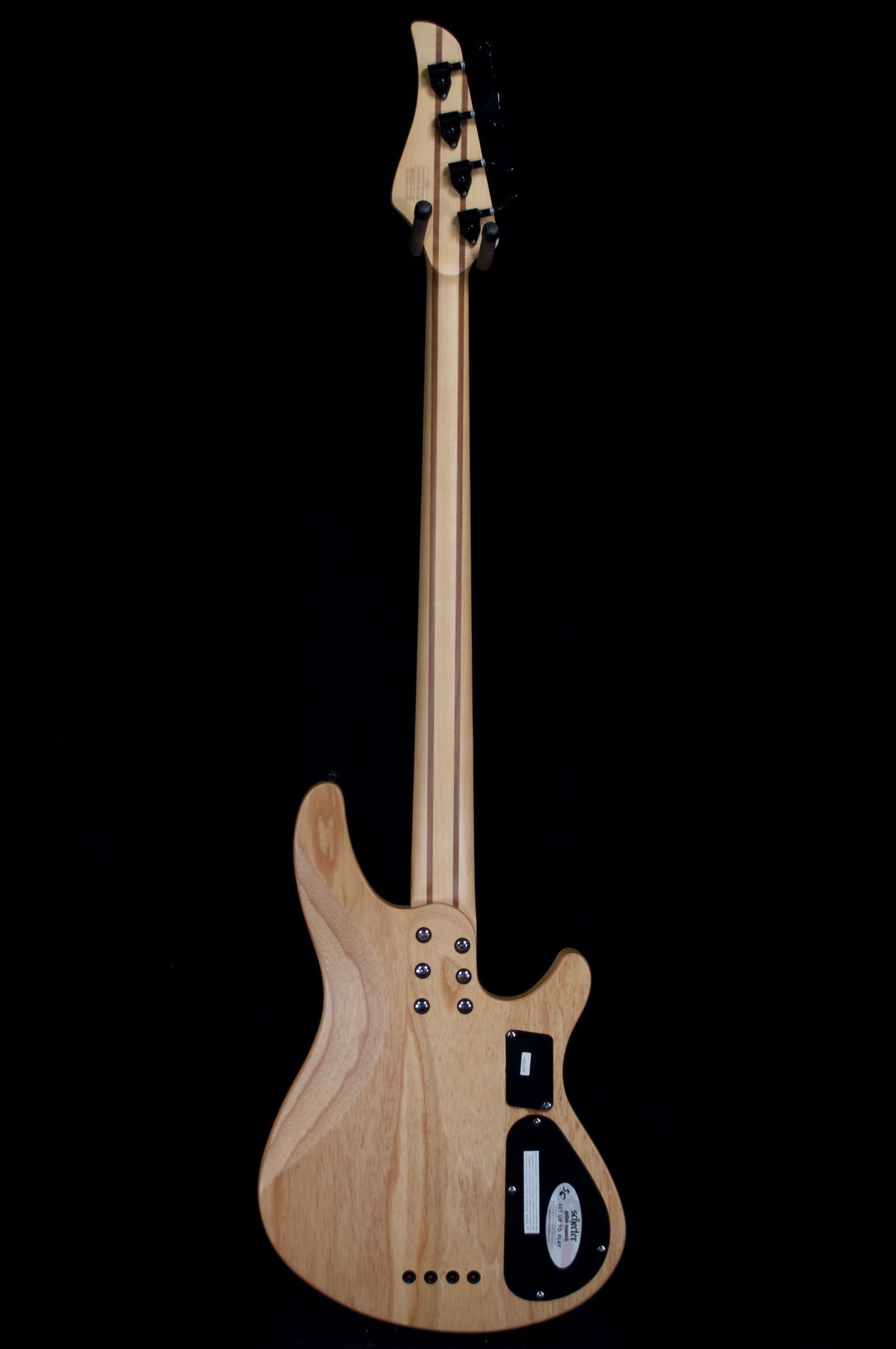 Electric guitar with a natural wood finish on a black background
