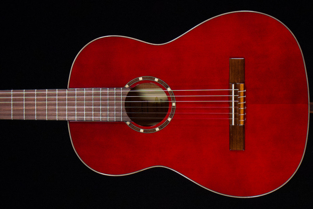 Left-handed Ortega classical acoustic guitar in a warm red finish