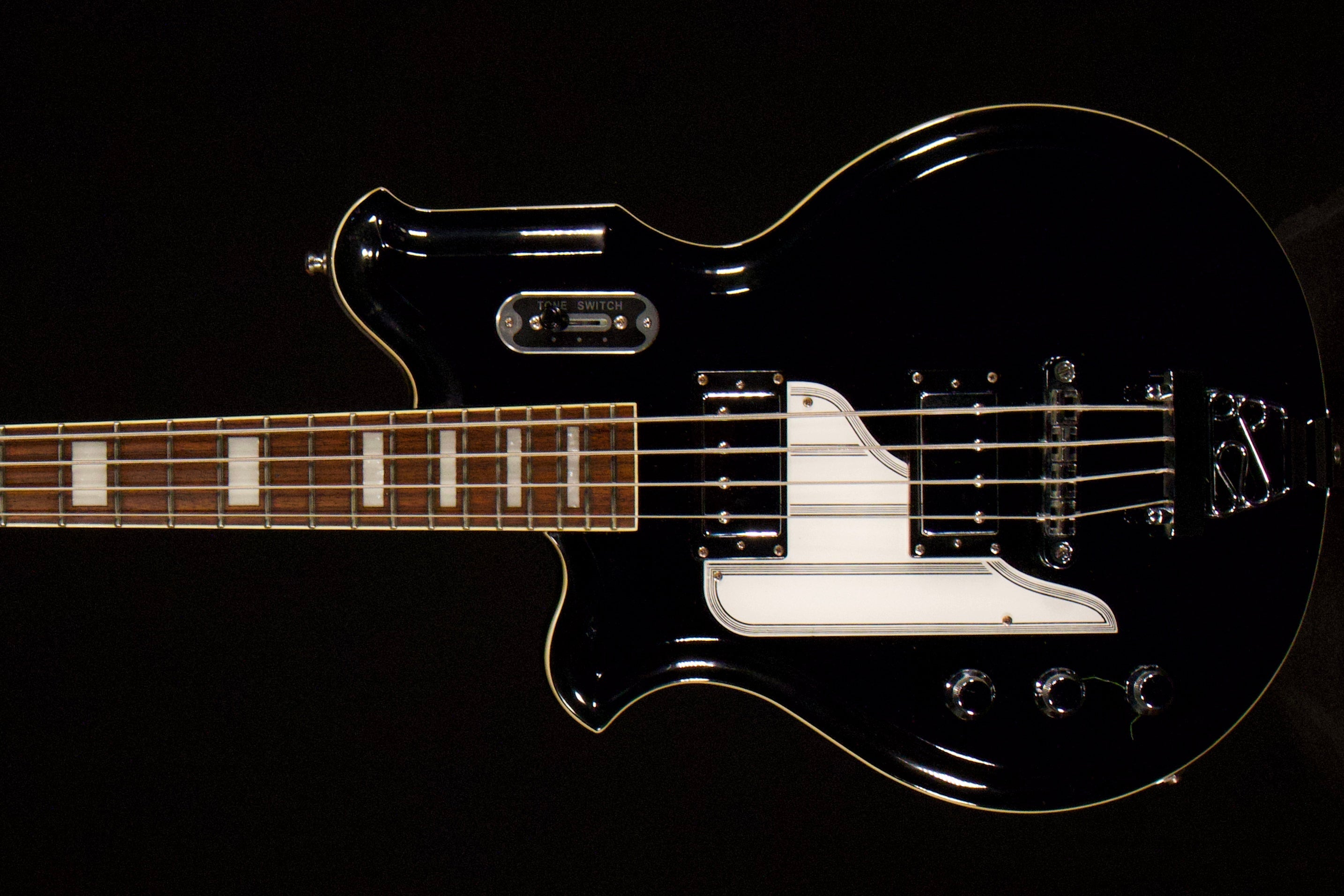 Left-handed Airline MAP Bass shown close up against a dark background