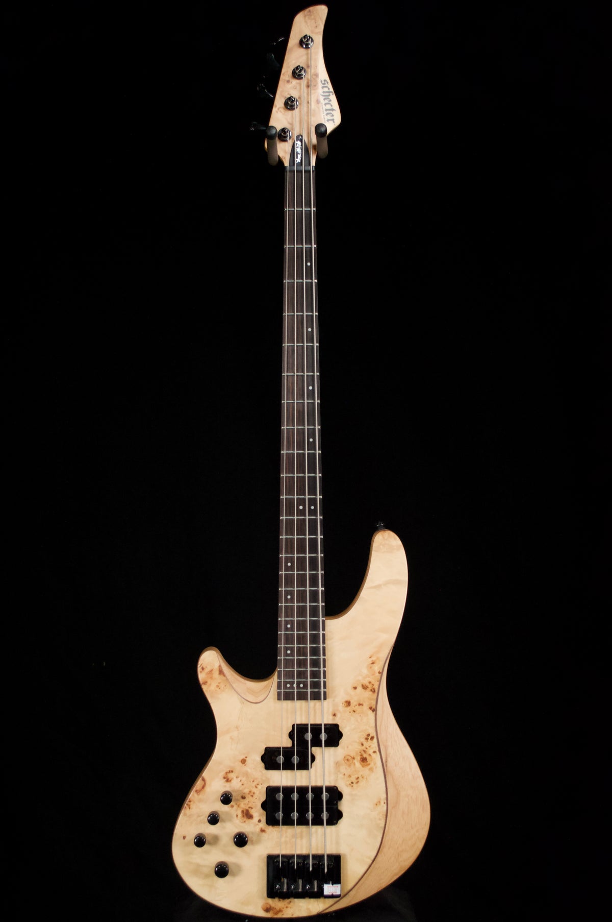 Electric bass guitar with a worn finish on a black background