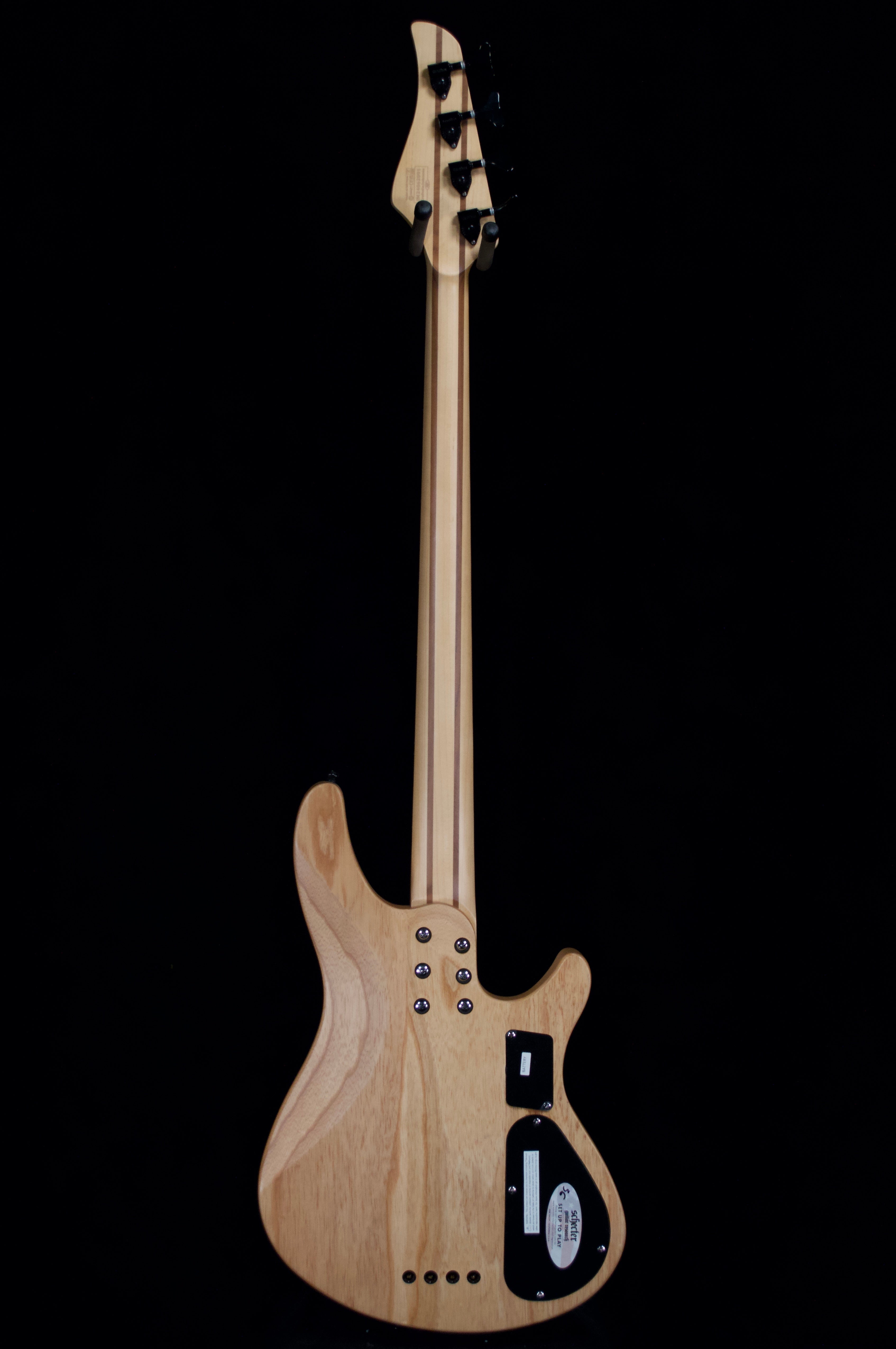 Electric guitar with a natural wood finish on a black background